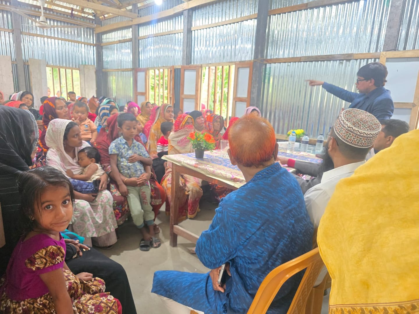 Women and children at a community gathering, December 2025