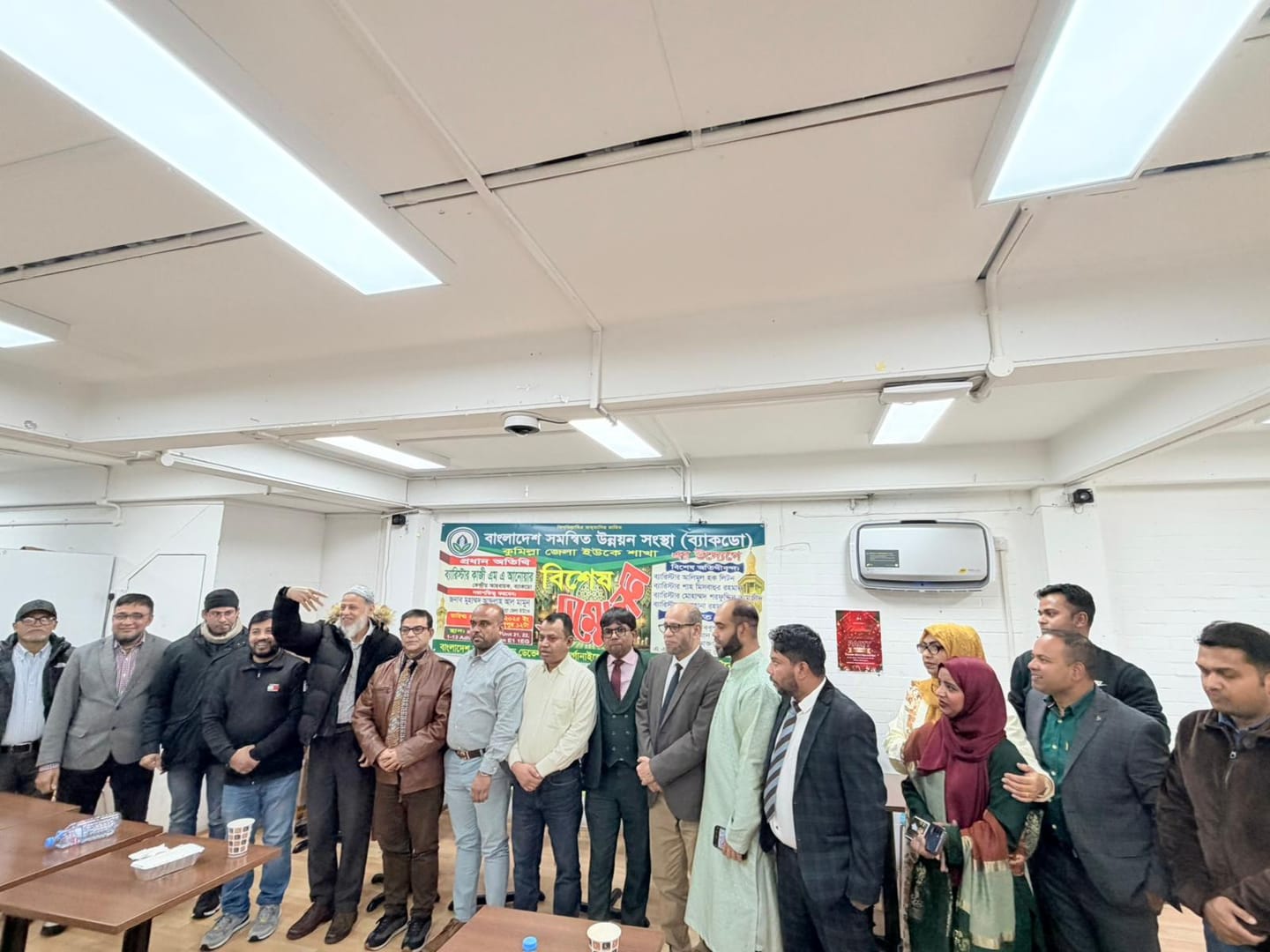 Members of the organisation together in front of the conference banner